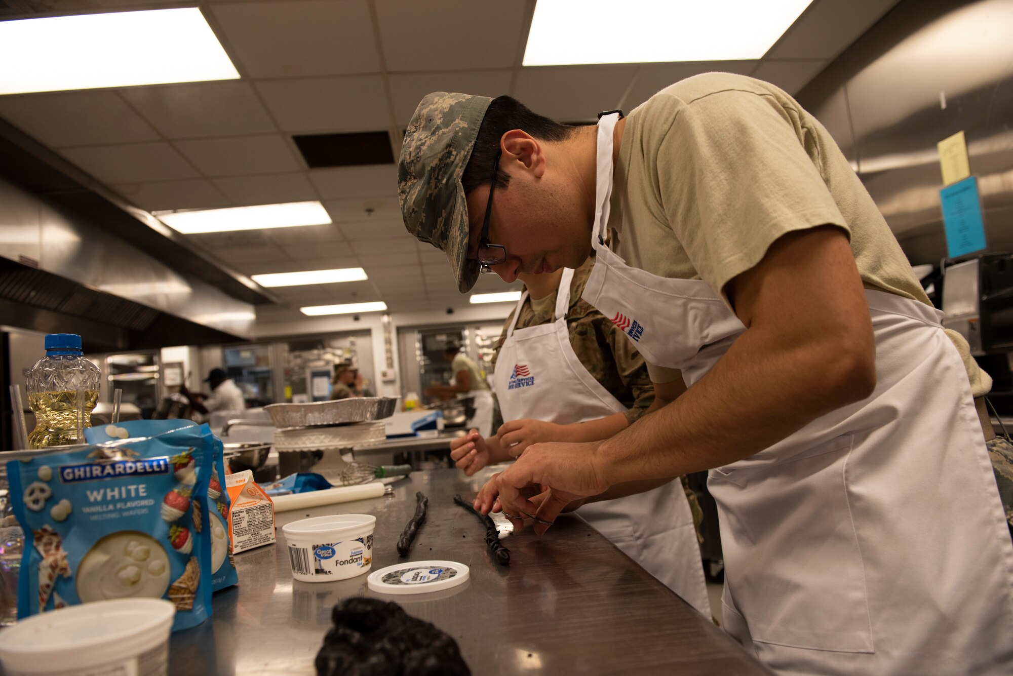2nd Lt. Dallas Cook, 23d Maintenance Squadron section commander, prepares cake designs during a Scary Cake Bake-Off Oct. 23, 2019, at Moody Air Force Base, Ga. The event, hosted by the 23d Force Support Squadron, pitted two teams against each other to bake and design a Halloween-themed cake. In the end, the three judges declared Ight Imma Head Out the winning team. (U.S. Air Force photo by Airman Elijah M. Dority)