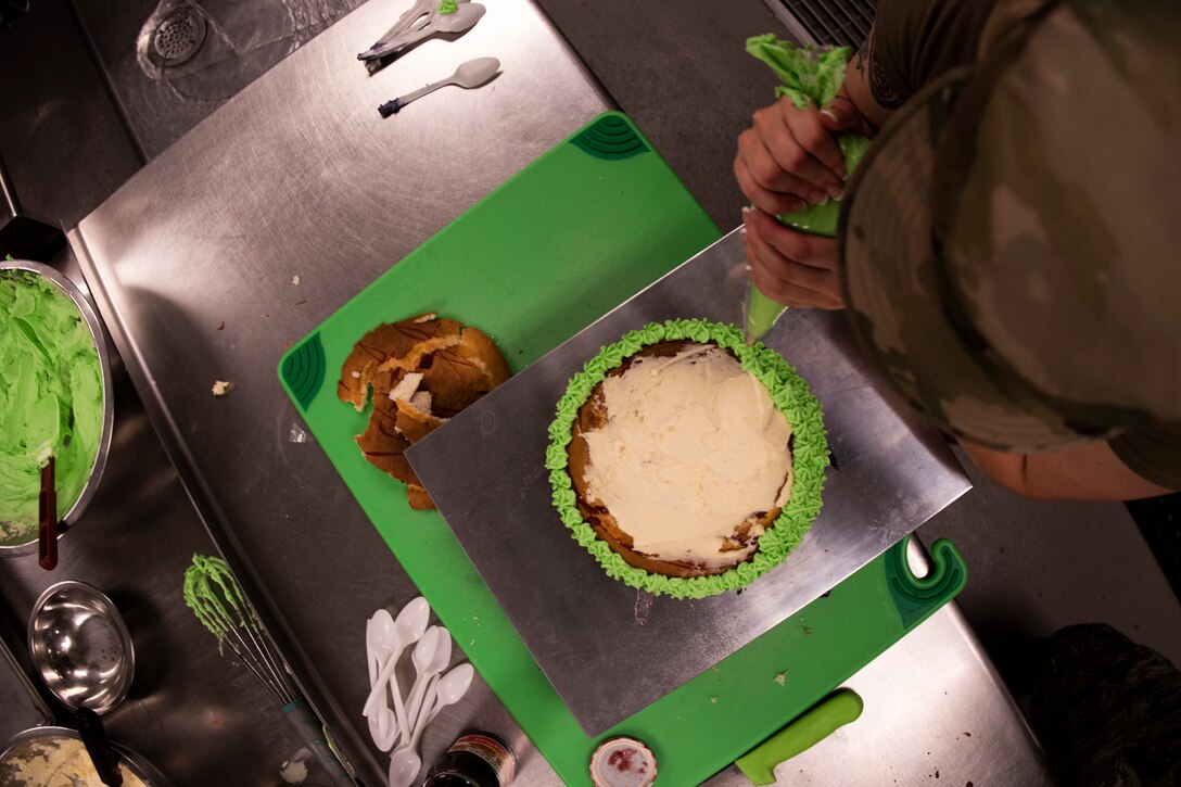 Staff Sgt. Ardella Biser, 23d Force Support Squadron (FSS) fitness shift leader, puts icing on a cake during a Scary Cake Bake-Off Oct. 23, 2019, at Moody Air Force Base, Ga. The event, hosted by the 23d FSS, pitted two teams against each other to bake and design a Halloween-themed cake. In the end, the three judges declared Ight Imma Head Out the winning team. (U.S. Air Force photo by Airman Elijah M. Dority)