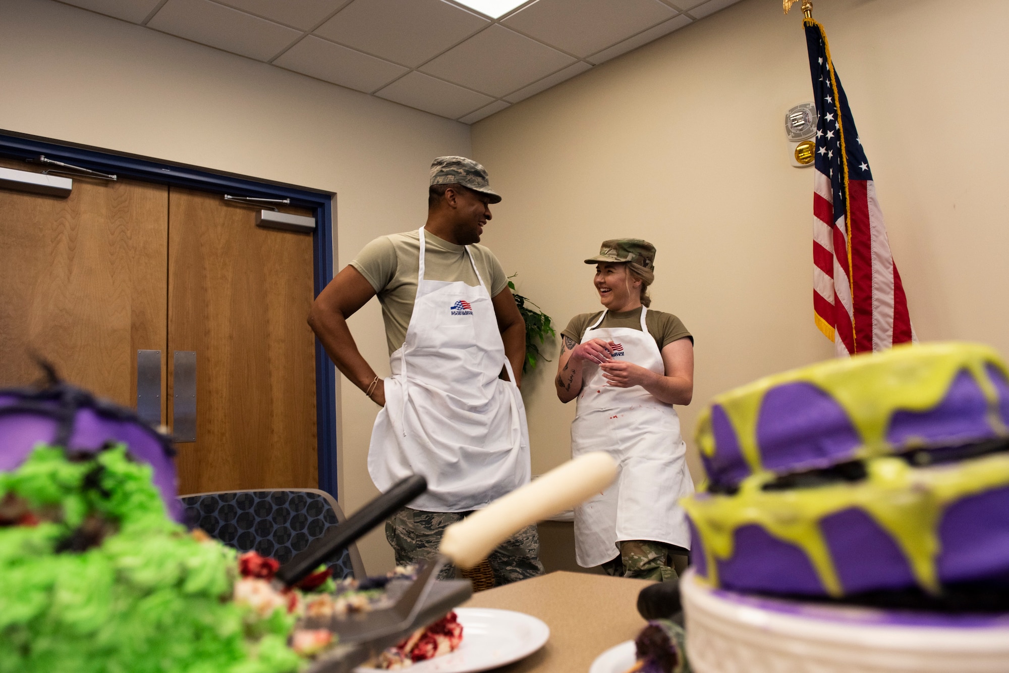 Staff Sgt. Ardella Biser, right, 23d Force Support Squadron (FSS) fitness shift leader, shares a laugh with Staff Sgt. Cameron Morrow, 23d FSS honor guard trainer, during a Scary Cake Bake-Off Oct. 23, 2019, at Moody Air Force Base, Ga. The event, hosted by the 23d FSS, pitted two teams against each other to bake and design a Halloween-themed cake. In the end, the three judges declared Ight Imma Head Out the winning team. (U.S. Air Force photo by Airman Elijah M. Dority)