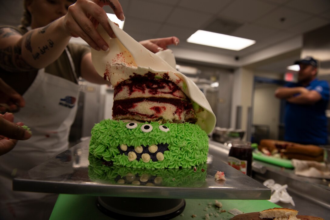 Staff Sgt. Ardella Biser, 23d Force Support Squadron (FSS) fitness shift leader, puts fondant on top of a cake during a Scary Cake Bake-Off Oct. 23, 2019, at Moody Air Force Base, Ga. The event, hosted by the 23d FSS, pitted two teams against each other to bake and design a Halloween-themed cake. In the end, the three judges declared Ight Imma Head Out the winning team. (U.S. Air Force photo by Airman Elijah M. Dority)
