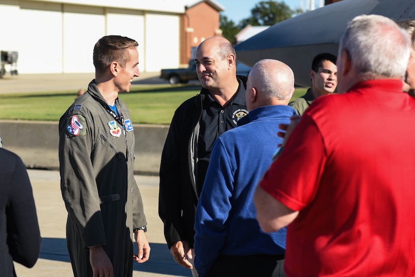 .S. Air Force Capt. John Steele, 94th Fighter Squadron F-22 Raptor pilot, speaks with 1st Fighter Wing Alumni during the 1st Fighter Wing Association Reunion on Joint Base Langley-Eustis, Virginia, October 18, 2019. Steele, along with other current 1 FW Airmen, listened to stories of the unit’s past from members who were previously assigned to the Wing. (U.S. Air Force photo by Airman 1st Class Marcus M. Bullock)