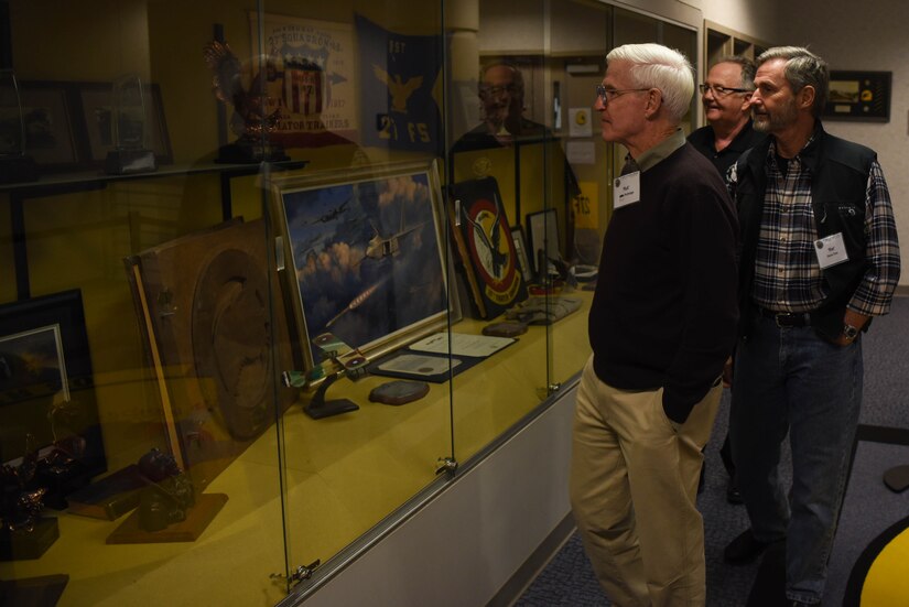 1st Fighter Wing Alumni review historic memorabilia during the 1st Fighter Wing Association Reunion at Joint Base Langley-Eustis, Virginia, Oct. 18, 2019. The reunion provided 1 FW alumni, who served in the Wing over the past five decades, an opportunity to reflect on the changes the unit has undergone since their time in uniform. (U.S. Air Force photo by Airman 1st Class Marcus M. Bullock)