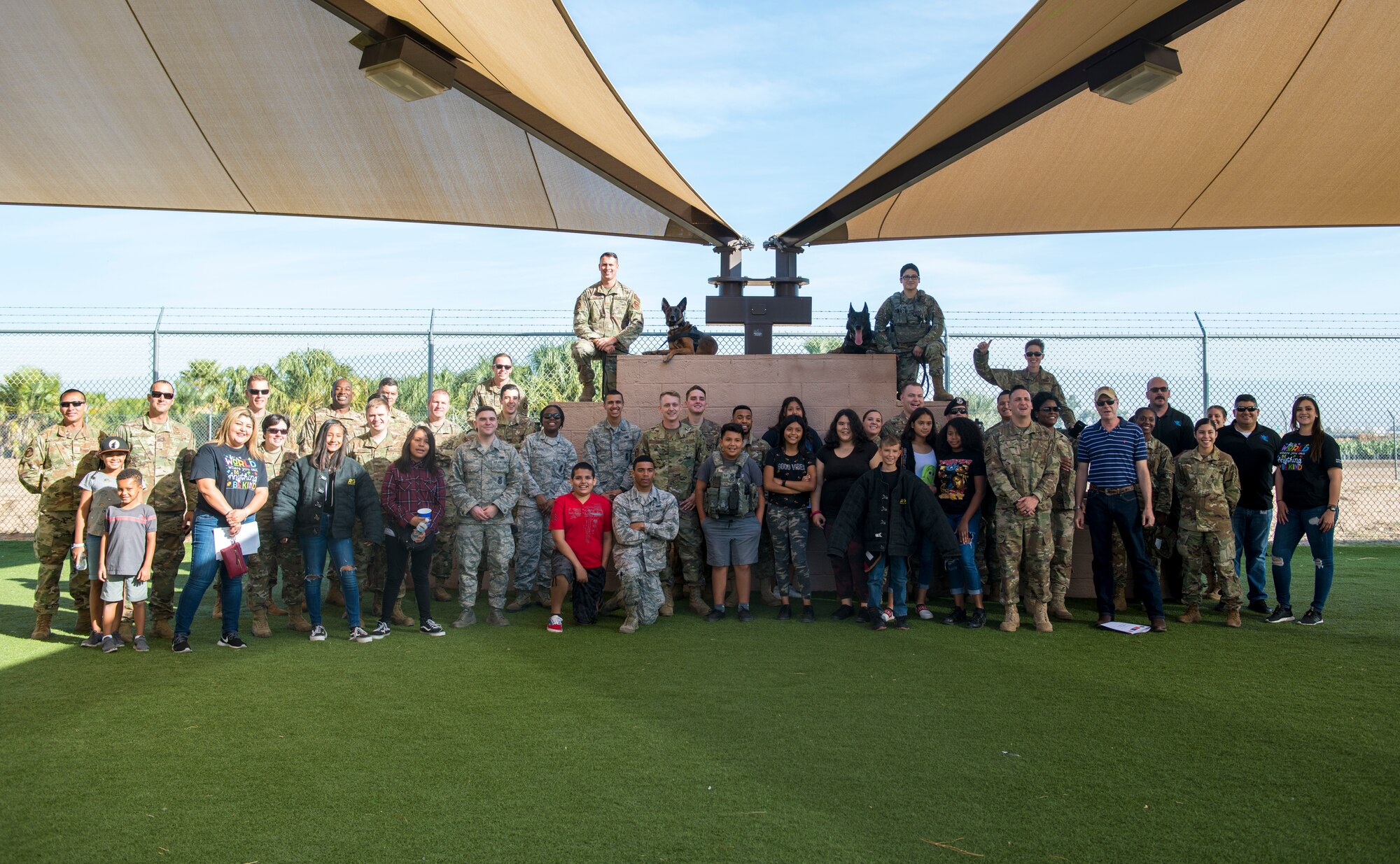 Airmen from the 56th Security Forces Squadron and members from the Childhelp program pose for a group photo during the Childhelp Kids Day of Hope tour Oct. 16, 2019, at Luke Air Force Base, Ariz.