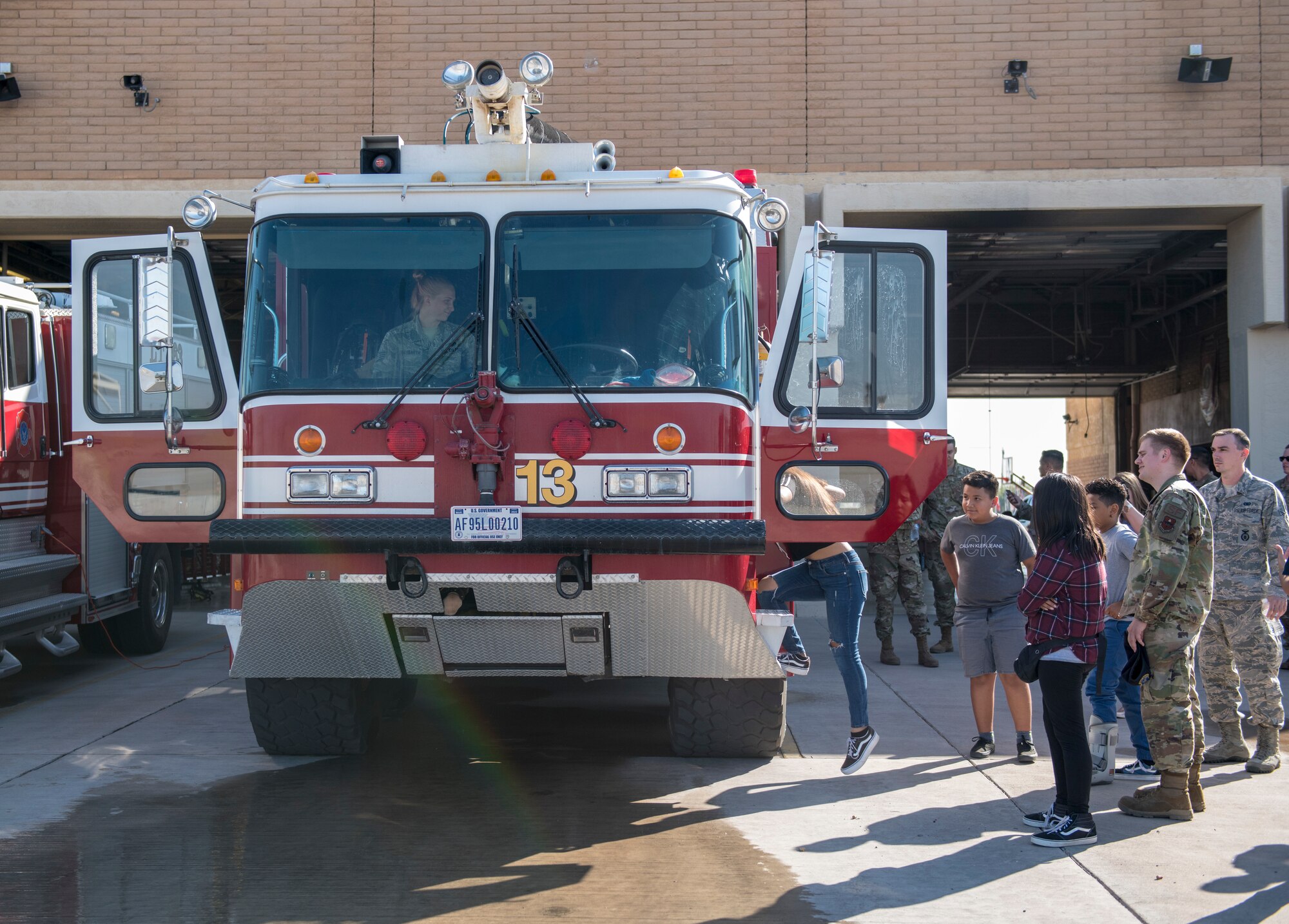 Firefighters from the 56th Civil Engineer Squadron show a fire engine to the members of the Childhelp program during the Childhelp Kids Day of Hope tour Oct. 16, 2019, at Luke Air Force Base, Ariz.
