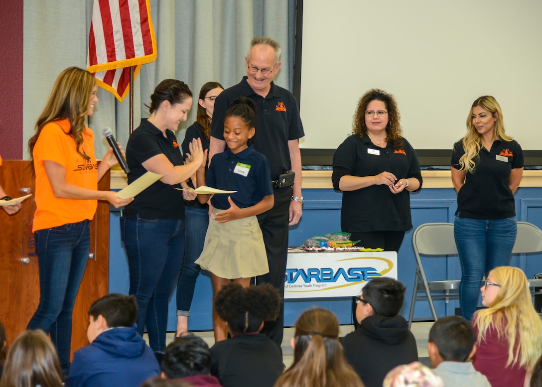 Caitlin Craig, STARBASE Edwards instructor, congratulates Cierra Gibson, a fifth grade STARBASE Edwards graduate and Student Council Vice-President, during the STARBASE graduation ceremony at the Idea Academy at Cottonwood Elementary School in Palmdale, California, Oct. 23. (U.S. Air Force photo by Giancarlo Casem)