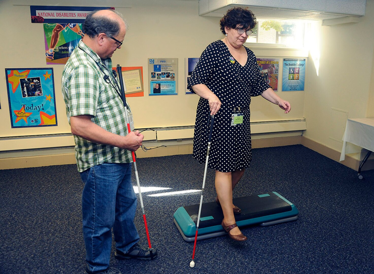 DLA Logistics Operations Program Analyst Michael Perez, a People With Disabilities Committee member, helps DLA Disposition Services’ Kathy Hausknecht through a limited visibility exercise during the Disability Challenge at the Hart-Dole-Inouye Federal Center in Battle Creek, Michigan, Oct. 23.