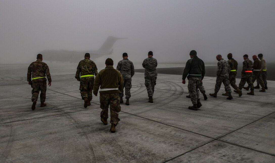 Members of the 911th Airlift Wing look for foreign object debris during a FOD walk at Pittsburgh International Airport Air Reserve Station, Pa., Oct. 21, 2019.