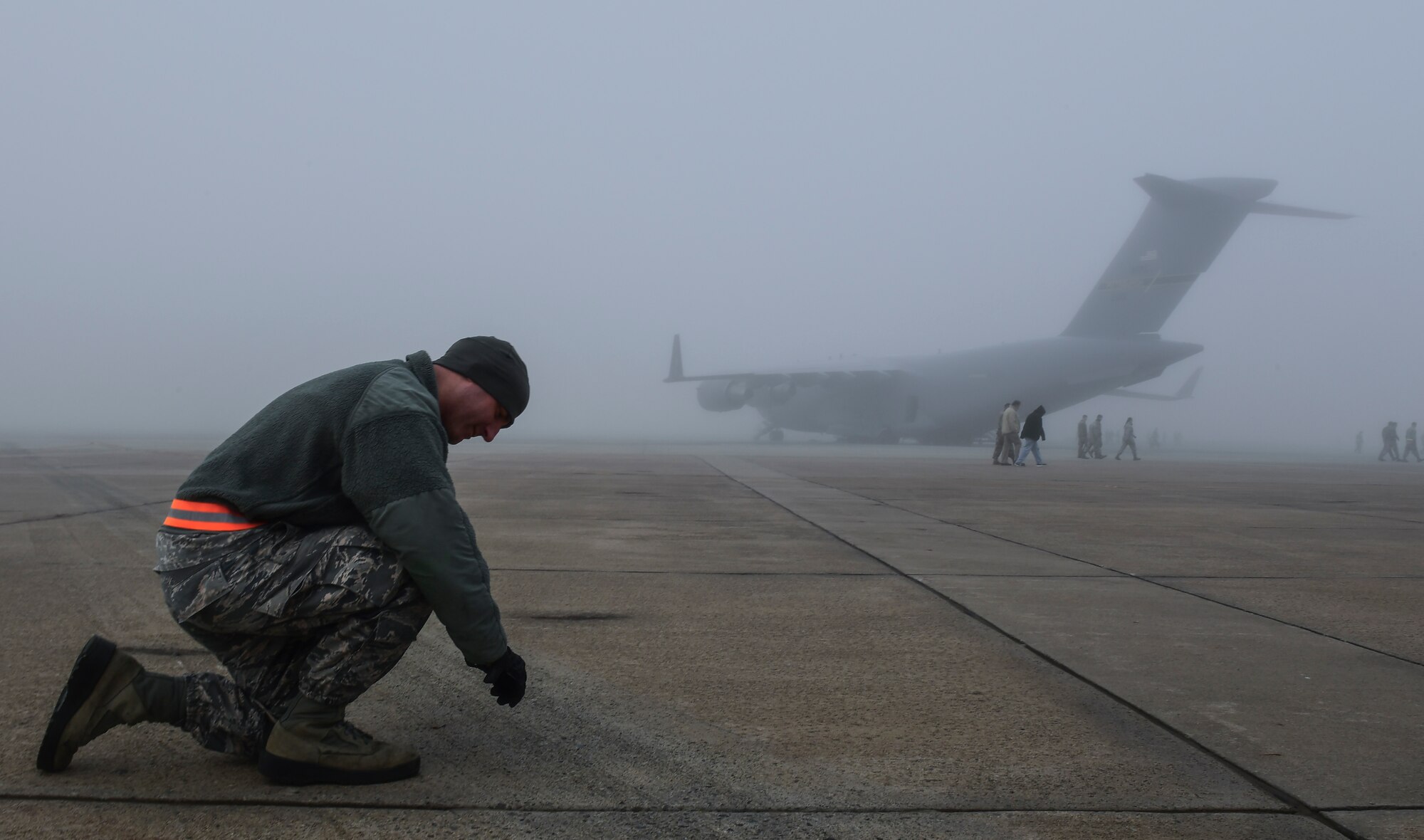 Staff Sgt. David Barbieri, 911th Aircraft Maintenance Squadron crew chief, picks up a piece of foreign object debris during a FOD walk at Pittsburgh International Airport Air Reserve Station, Pennsylvania, Oct. 29, 2019.