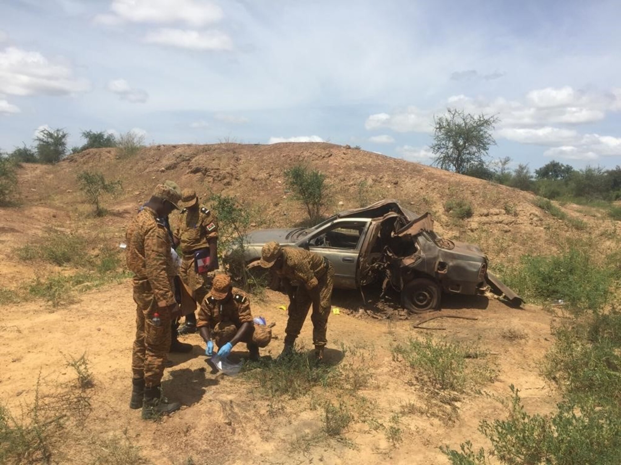 Burkinabe Gendarme collect evidence following an improvised explosive device detonating inside a vehicle during the Air Force Office of Special Investigations Expeditionary Detachment 2502-led Advanced Post-Blast Analysis and Evidence Preservation Engagement with the Burkinabe Gendarme in Ouagadougou, Burkina Faso, Oct. 7-11, 2019. (Photo by AFOSI EDet 2502)