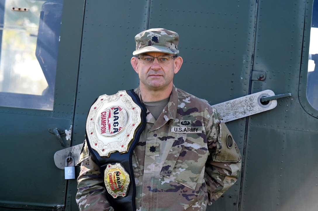 Lt. Col. Pete Caragher, Deputy G-3, 85th U.S. Army Support Command, pauses for a photo with his first place belt in the expert category from the 2012 New England Championships in Springfield, Massachusetts.