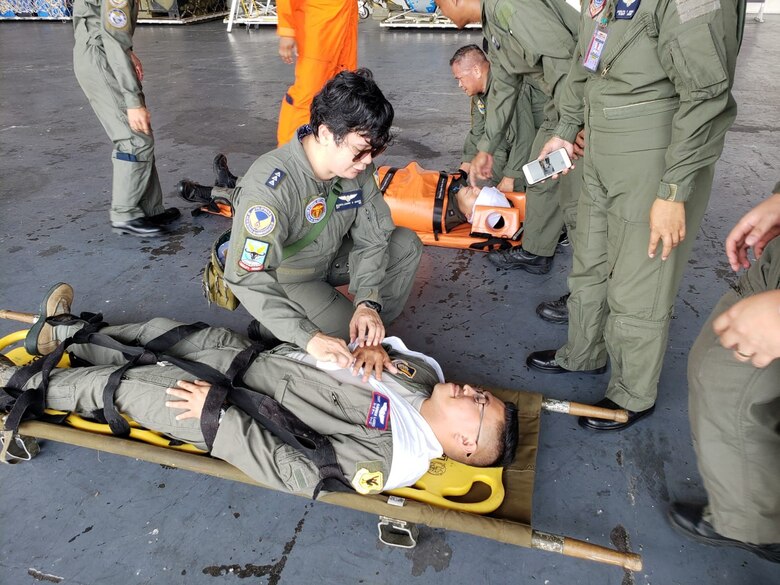 A Philippine air force Flight Nurse demonstrates assessment of Tech. Sgt. Rainer Largo 18 Aeromedical Evacuation Squadron, a simulated critically injured U.S. Air Force patient, Clark Air Base, Philippines, September 11, 2019. (Courtesy photo)