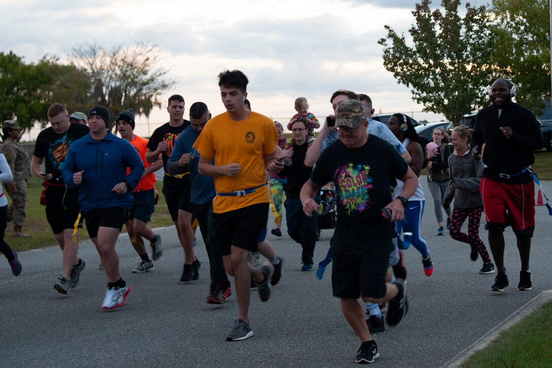 Zombie Run participants run Oct. 24, 2019, at Moody Air Force Base, Ga. Participants began the run with two flags on their belts to identify their "lives." Each participant was challenged with running from volunteers dressed as zombies, ensuring participants do not lose a "life." (U.S. Air Force photo by Airman 1st Class Jasmine M. Barnes)