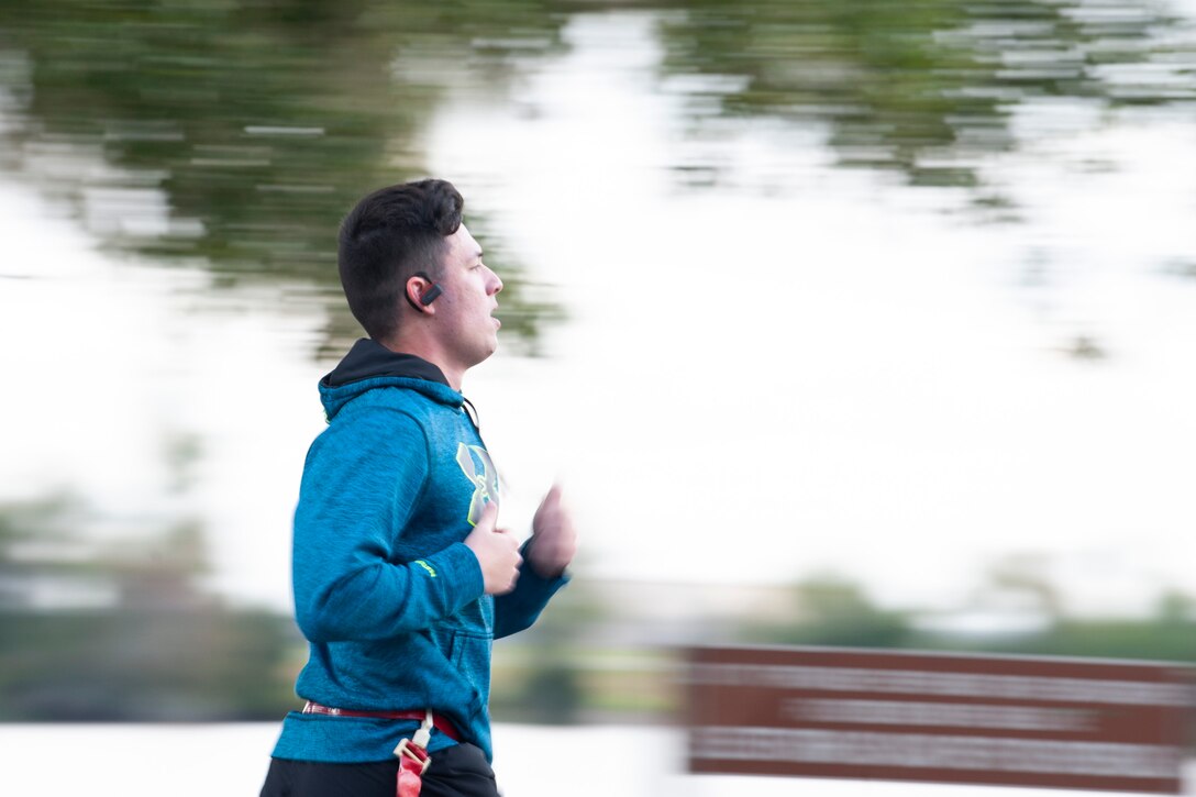 A Zombie Run participant runs Oct. 24, 2019, at Moody Air Force Base, Ga. Participants began the run with two flags on their belts to identify their "lives." Each participant was challenged with running from volunteers dressed as zombies, ensuring participants do not lose a "life." (U.S. Air Force photo by Airman 1st Class Jasmine M. Barnes)