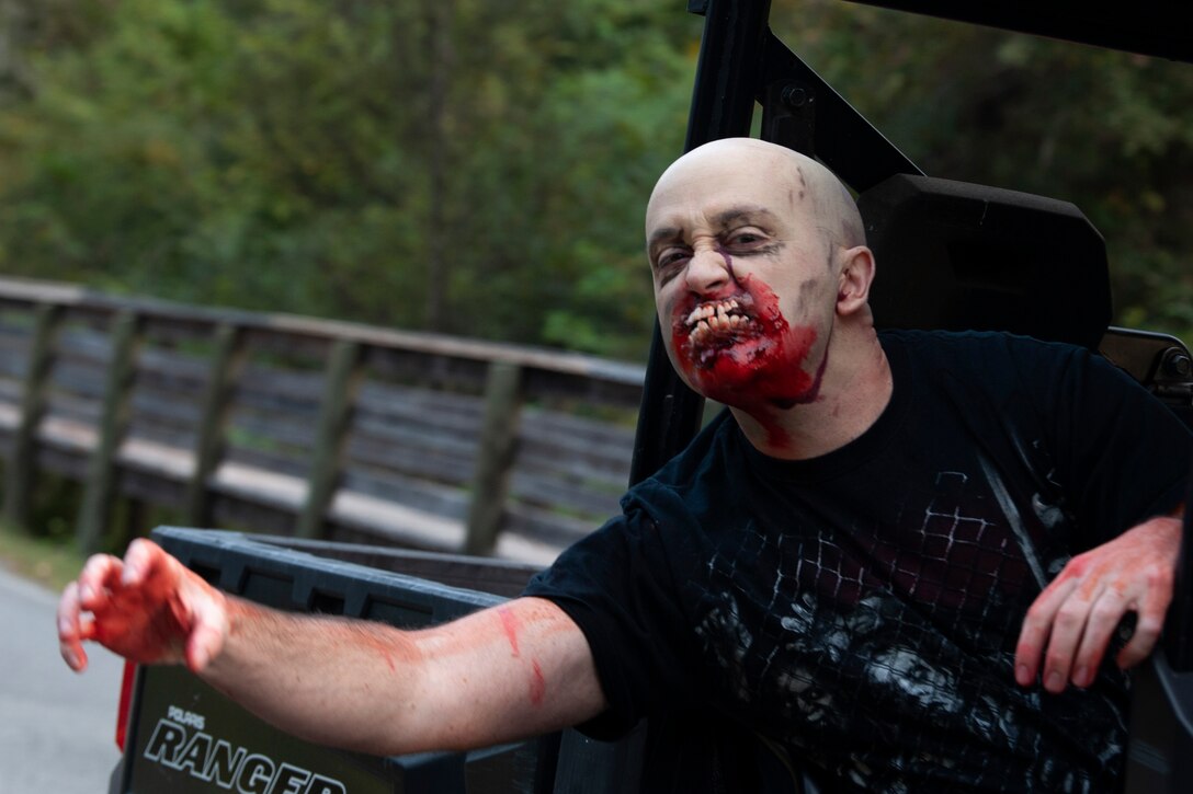 A Zombie Run volunteer extends his arm Oct. 24, 2019, at Moody Air Force Base, Ga. Participants began the run with two flags on their belts to identify their "lives." Each participant was challenged with running from volunteers dressed as zombies, ensuring participants do not lose a "life." (U.S. Air Force photo by Airman 1st Class Jasmine M. Barnes)