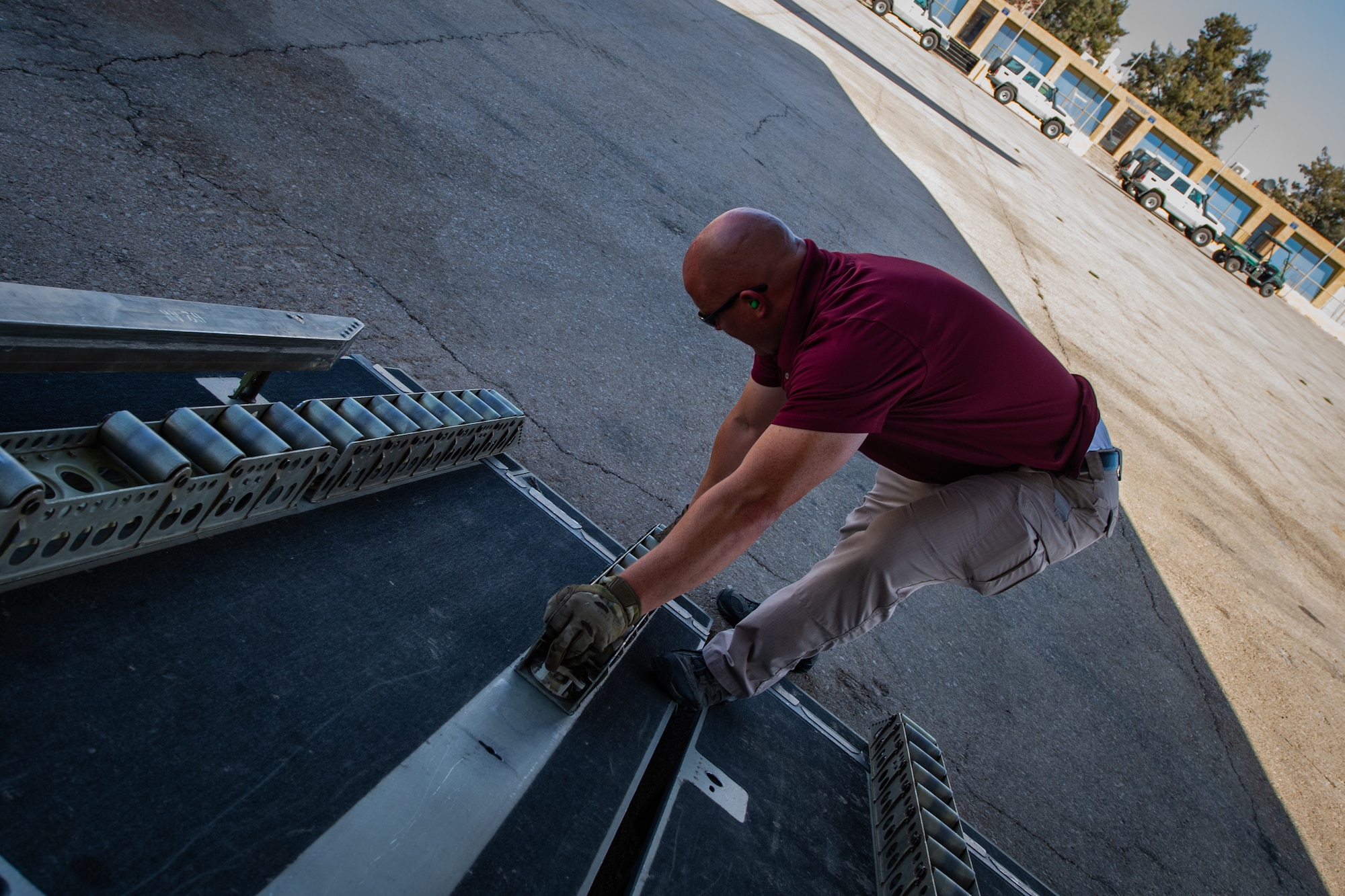 Tech. Sgt. Kyle Hersel, Assistant NCO-in-charge of Air Terminal Operations, Jordan Port, 387th Air Expeditionary Squadron, replaces cargo rollers on a U.S. Air Force C-17 Globemaster III in Jordan, Oct. 14, 2019. The port provides aerial logistics for the American Embassy to Jordan through the Military Assistance Program, handling cargo and passenger movement in support of State Department efforts.