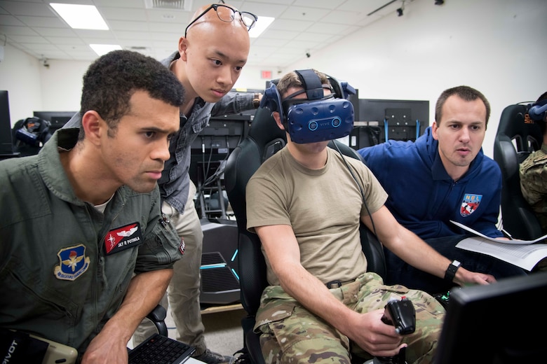 U.S. Air Force Capt. Jay Pothula, Pilot Training Next instructor pilot, and NASA officials observe a future student of PTN version three during a virtual reality flight at Joint Base San Antonio-Randolph, Texas, Oct. 22, 2019, as part of a collaborative research agreement between PTN and NASA. The partnership will focus on biometric data collection and the application of emerging technology into PTN curriculum that will innovate the student pilot learning environment. (U.S. Air Force photo by Sean M. Worrell)