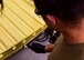 Airmen puts adhesive on sheet metal