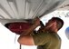 Airman drills sheet metal onto HC-130J Combat King II