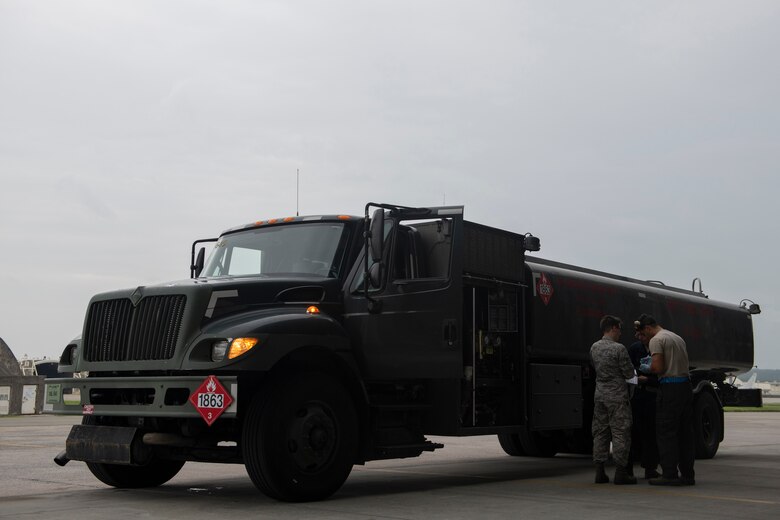 U.S. Air Force Senior Airman Dylan Heaton, 18th Logistics Readiness Squadron fuels distribution operator, and an 18th Aircraft Maintenance Squadron crew chief discuss the refueling requirements of an F-15C Eagle at Kadena Air Base, Japan, Sept. 18, 2019. The 18th LRS petroleum, oil and lubricants flight supports all home station and transient aircraft, managing 1.3M gallons of fuel annually for 320 organizations. (U.S. Air Force photo by Tech. Sgt. Matthew B. Fredericks)