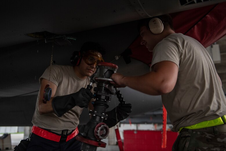 U.S. Air Force Airman 1st Class Auggie Toppo, 18th Logistics Readiness Squadron fuels distribution operator, works with an 18th Aircraft Maintenance Squadron crew chief to detach the fuel hose after refueling an F-15C Eagle at Kadena Air Base, Japan, Sept. 18, 2019. The 18th LRS petroleum, oil and lubricants flight supports all home station and transient aircraft, managing 1.3M gallons of fuel annually for 320 organizations. (U.S. Air Force photo by Tech. Sgt. Matthew B. Fredericks)