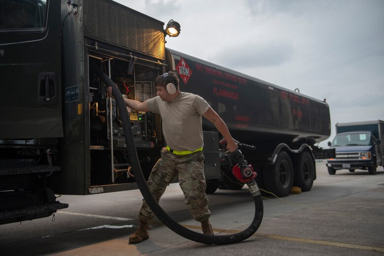U.S. Air Force Airman 1st Class Auggie Toppo, 18th Logistics Readiness Squadron fuels distribution operator, rolls up the fuel hose after refueling an F-15C Eagle at Kadena Air Base, Japan, Sept. 18, 2019. The 18th LRS petroleum, oil and lubricants flight supports all home station and transient aircraft, managing 1.3M gallons of fuel annually for 320 organizations. (U.S. Air Force photo by Tech. Sgt. Matthew B. Fredericks)