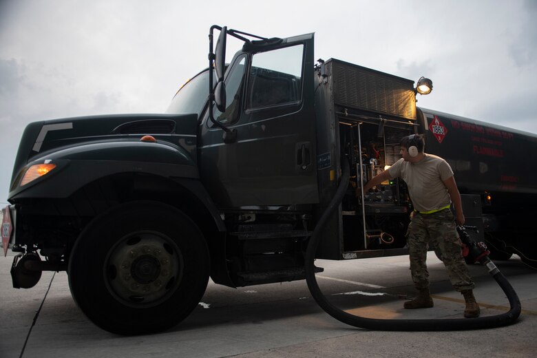 U.S. Air Force Airman 1st Class Auggie Toppo, 18th Logistics Readiness Squadron fuels distribution operator, rolls up the fuel hose after refueling an F-15C Eagle at Kadena Air Base, Japan, Sept. 18, 2019. The 18th LRS petroleum, oil and lubricants flight supports all home station and transient aircraft, managing 1.3M gallons of fuel annually for 320 organizations. (U.S. Air Force photo by Tech. Sgt. Matthew B. Fredericks)