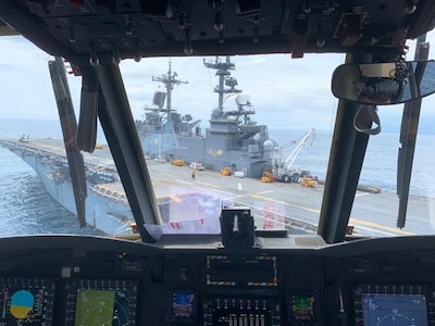 the view of the landing deck of the USS Wasp from the cockpit of a CH-47 Chinook.