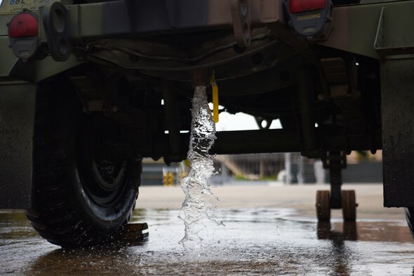 Water simulating a fuel spill rushes out of a water buffalo tank, signaling the start of the fuel spill exercise at Osan Air Base, Republic of Korea, October 18, 2019. Multiple agencies like Bioenvironmental Engineering, Fire Department and Security Forces cooperate to plan and train for fuel spill incidents on an annual basis to increase their standard of readiness. (U.S. Air Force photo by Staff Sgt. Benjamin Bugenig)