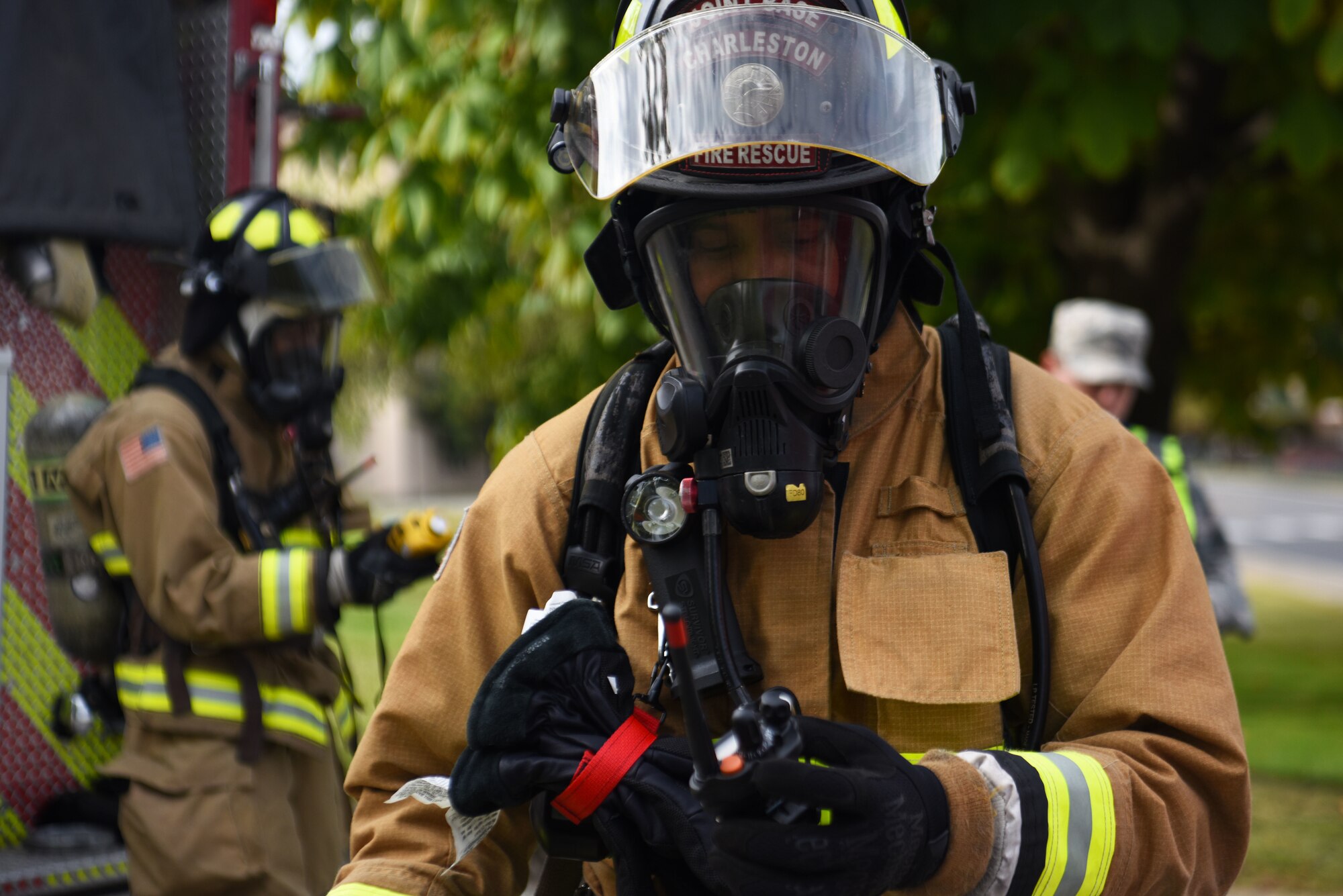 Fire fighters from the 51st Civil Engineer Squadron suit up and check if their equipment is operational before heading into the fuel spill site at Osan Air Base, October 18, 2019. The 51st CES Fire Department is one of the first emergency services to respond to the fuel spill because of immediate access to equipment in emergency situations such as this one. (U.S. Air Force photo by Staff Sgt. Benjamin Bugenig)