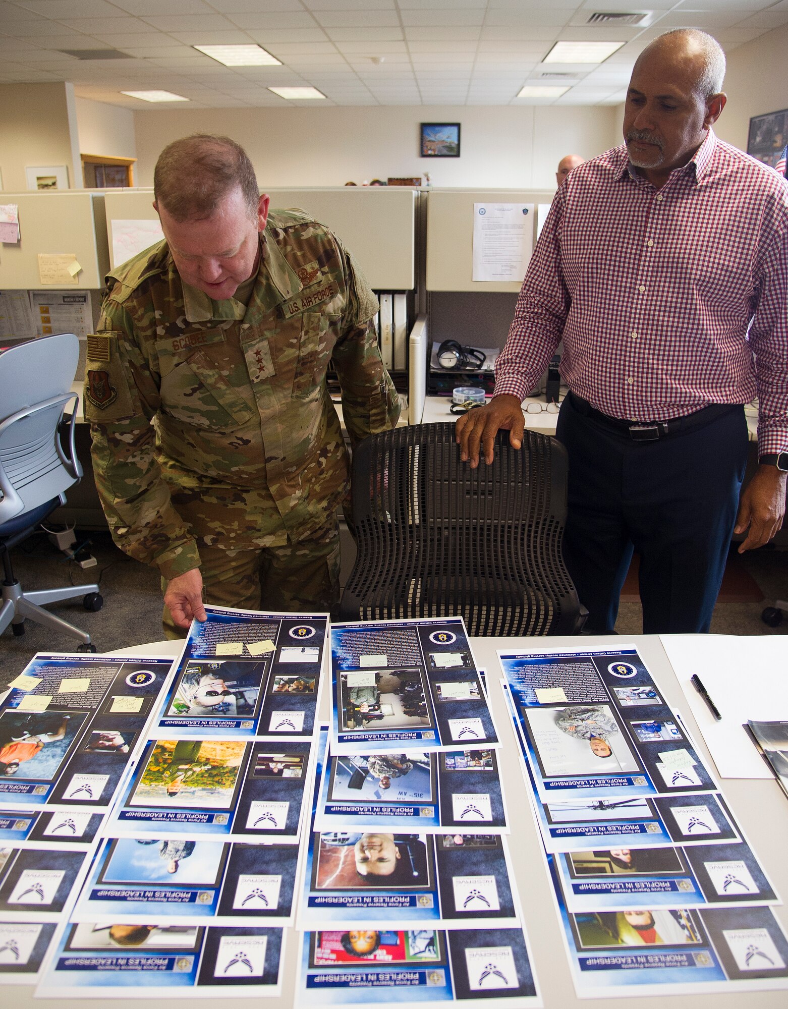 Lt. Gen. Richard W. Scobee, Commander, Air Force Reserve Command, looks over the Profiles in Leadership printouts with Phil Rhodes, a public affairs specialist, during a tour of the AFRC PA facilities, Robins Air Force Base, Ga., November 8, 2018. (U.S. Air Force photo by Master Sgt. Stephen D. Schester)