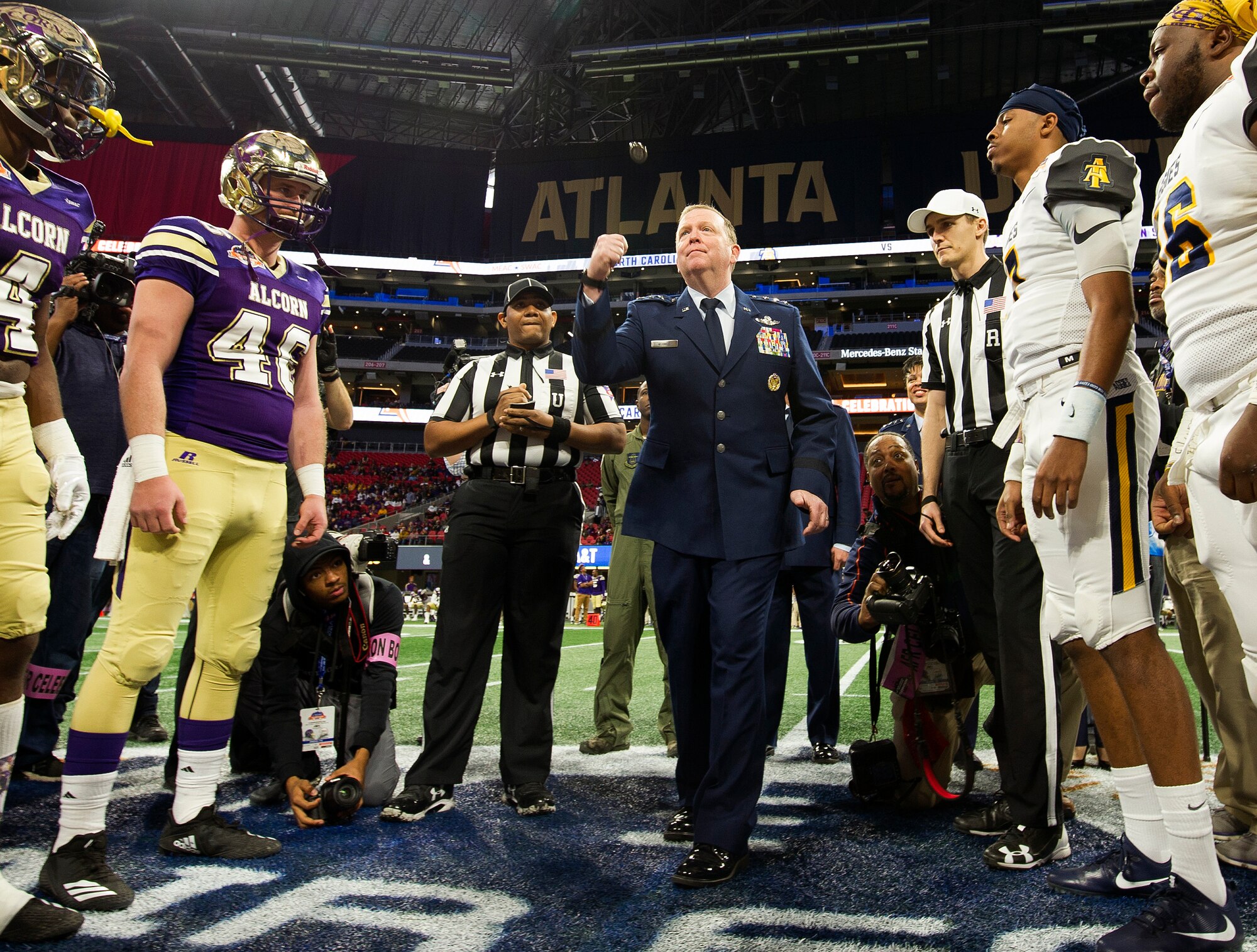 Lt. Gen. Richard W. Scobee, Commander, Air Force Reserve Command, tosses the game coin in the air at midfield of the Mercedes-Benz Stadium in Atlanta, Georgia, before the start of the Air Force Reserve Celebration Bowl, December 15, 2018. (U.S. Air Force photo by Master Sgt. Stephen D. Schester)