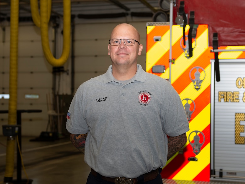 Capt. Matthew Grimes, Offutt Air Force Base Fire Department fireman, poses behind Offutt Fire & Rescue Engine 11 currently housed at Bellevue Fire District 4 in Bellevue, Nebraska. Grimes is a member of Offutt’s Fire Station 2 and is living and working alongside Bellevue Fire Department firefighters while Offutt AFB Fire Station 2 is undergoing renovations. The project is scheduled to be completed in March 2020.