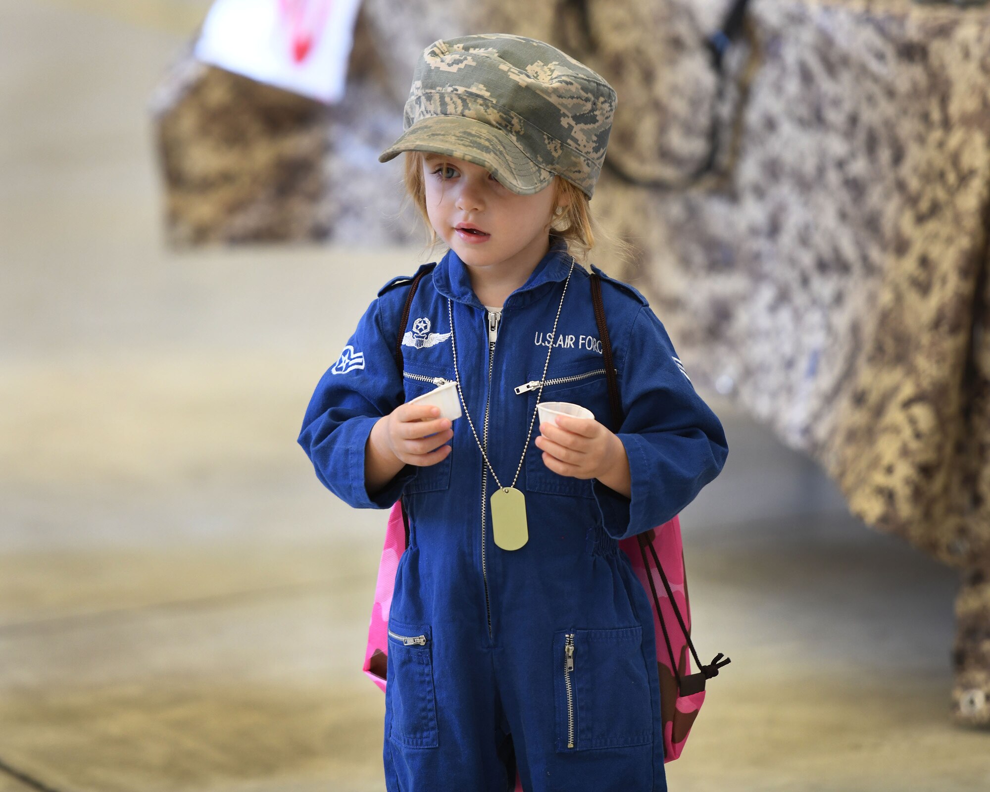 A child stands in a hangar.