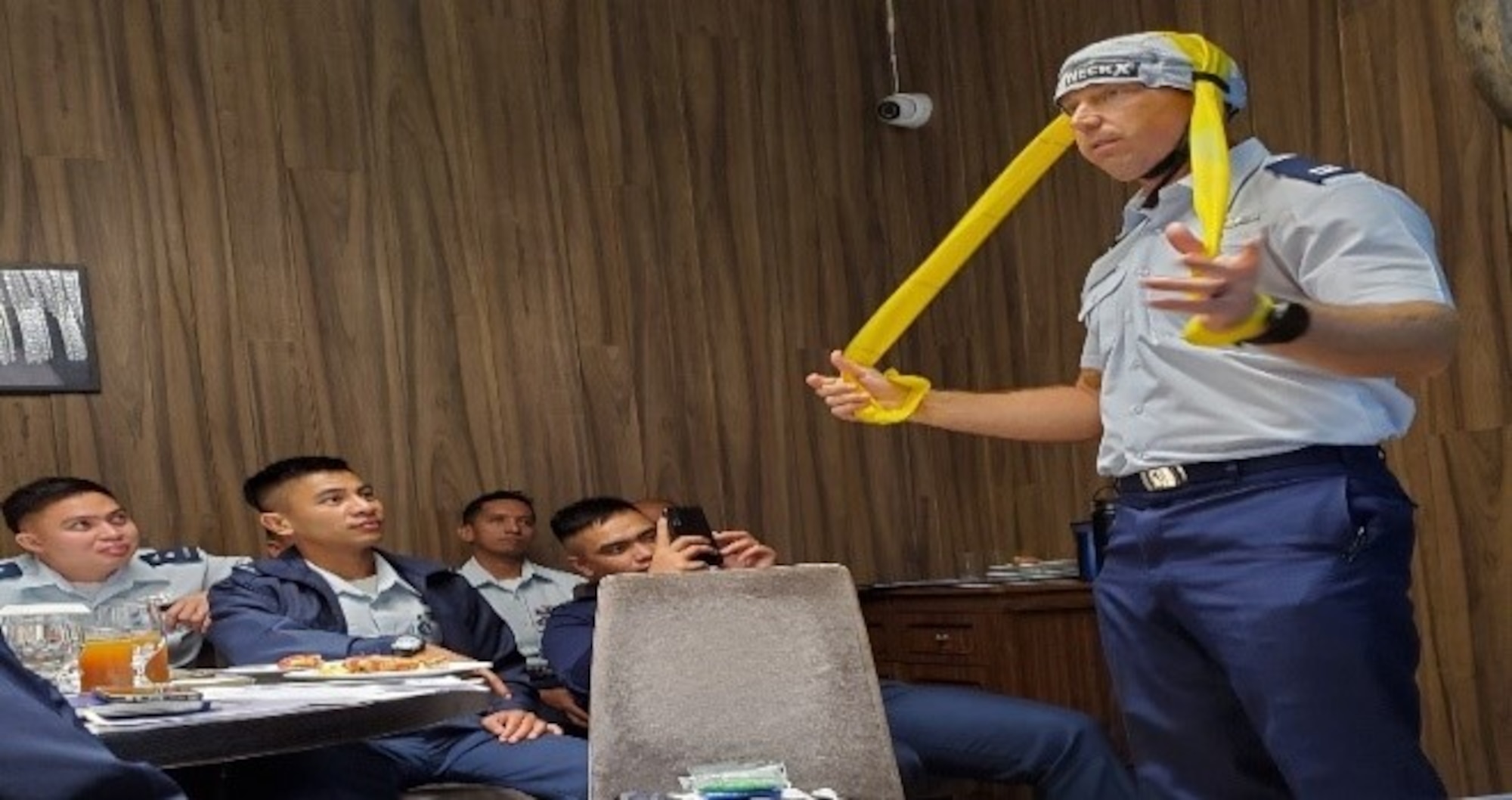 Capt. Judd Rogers, 56 Training Squadron Aerospace and Operational Physiologist, demonstrates a neck and back training device, September 11, 2019. (Courtesy photo)