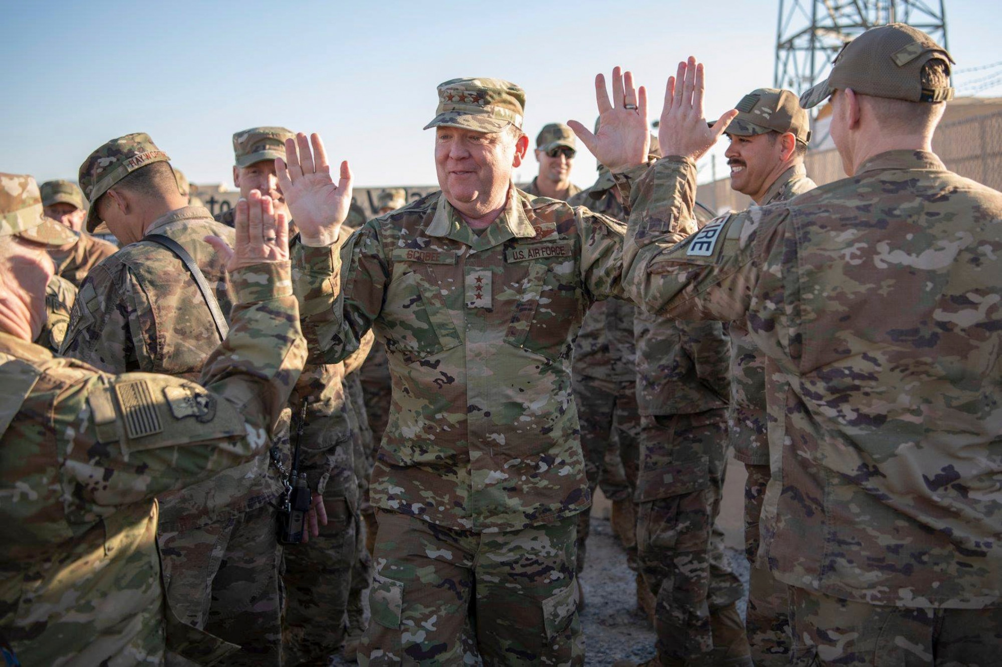 Lt. Gen. Richard W. Scobee, Commander, Air Force Reserve Command, high-fives members of the 386th Expeditionary Civil Engineer Squadron during a visit to an undisclosed location in Southwest Asia, Feb. 12, 2019. (U.S. Air Force Photo by Tech. Sgt. Robert Cloys)