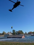 The Indiana Army National Guard Helicopter Aquatic Rescue Team and the South Bend Swift Water Rescue Team conduct hoist operations during monthly training Oct. 23-24, 2019, at the Muscatatuck Urban Training Center.