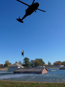 The Indiana Army National Guard Helicopter Aquatic Rescue Team and the South Bend Swift Water Rescue Team conduct hoist operations during monthly training Oct. 23-24, 2019, at the Muscatatuck Urban Training Center.
