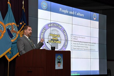 Man speaks behind podium