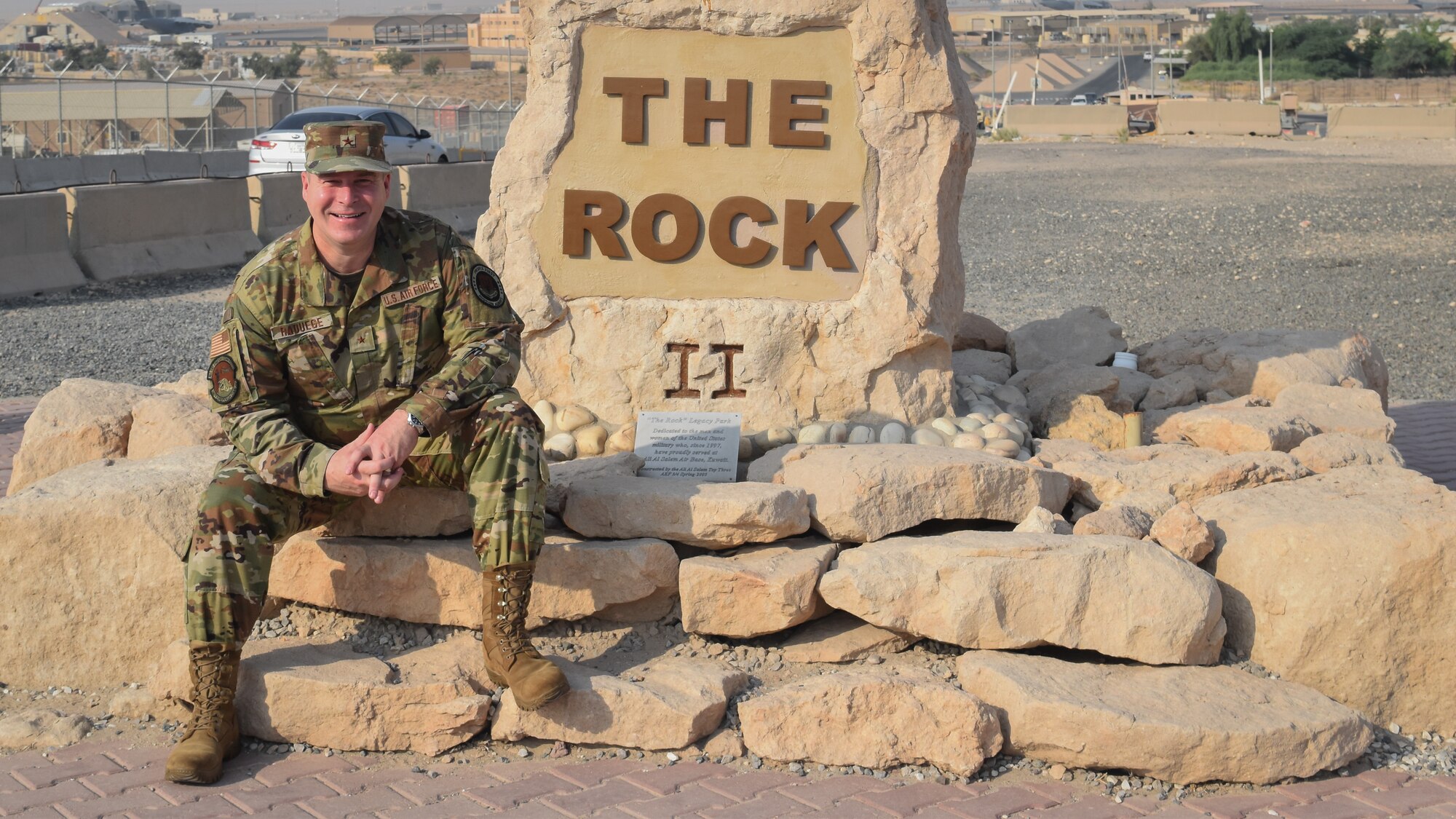 U.S. Air Force Brig. Gen. Chad Raduege, Air Combat Command director of cyberspace and information dominance, and chief information officer, takes a photo at "The Rock" on Ali Al Salem Air Base, Kuwait, Oct. 2, 2019. Raduege visited Airmen with the 386th Expeditionary Communications Squadron during a stop at ASAB enroute to the Air Forces Central Command A6 Commander's Summit at Al Udeid Air Base, Qatar. (U.S. Air Force photo by Chief Master Sgt. Joseph Hart)