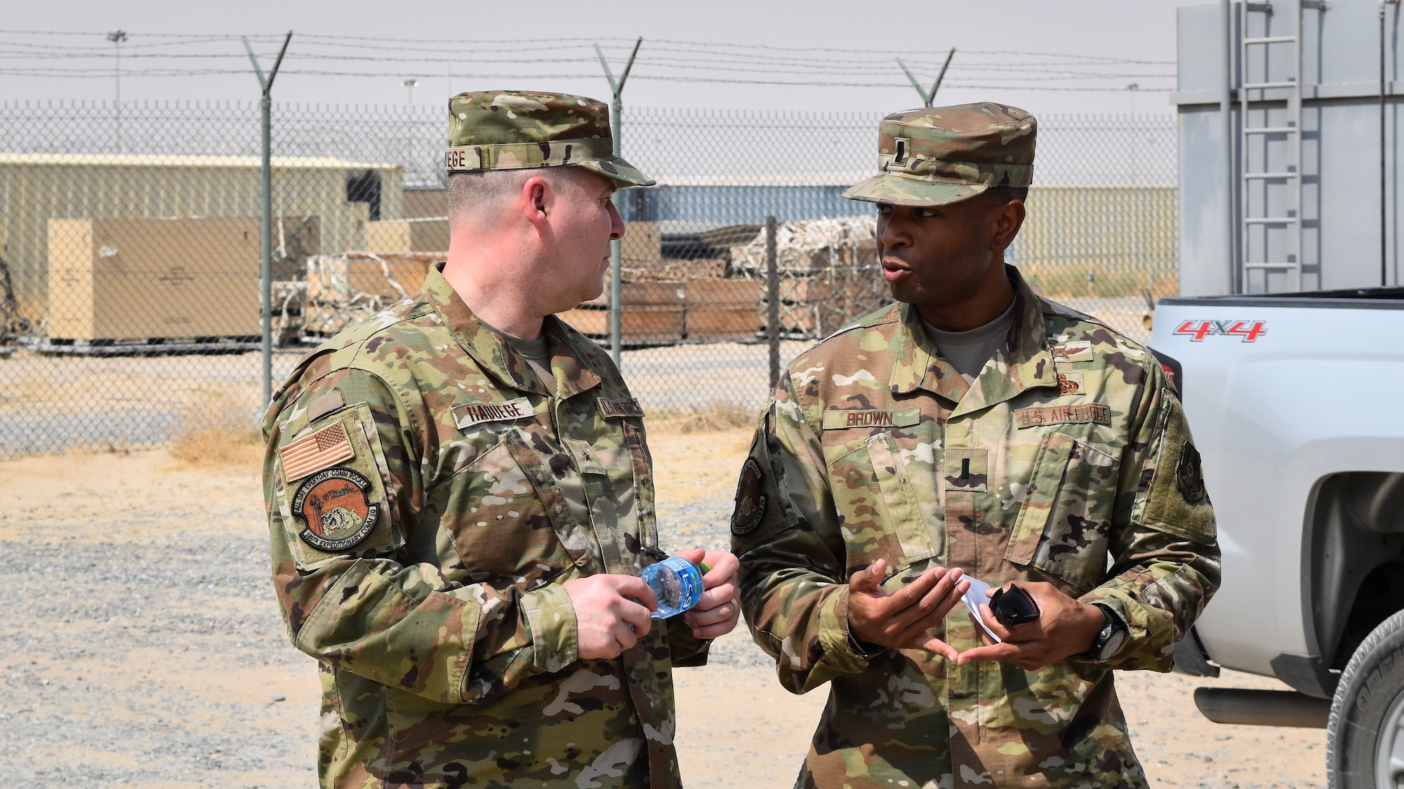 U.S. Air Force Brig. Gen. Chad Raduege, Air Combat Command director of cyberspace and information dominance, and chief information officer, listens to 1st Lt. Earl Brown, 386th Expeditionary Communications Squadron, while visiting Ali Al Salem Air Base, Kuwait, Oct. 2, 2019. Raduege visited Airmen with the 386th Expeditionary Communications Squadron during a stop at ASAB enroute to the Air Forces Central Command A6 Commander's Summit at Al Udeid Air Base, Qatar. (U.S. Air Force photo by Chief Master Sgt. Joseph Hart)