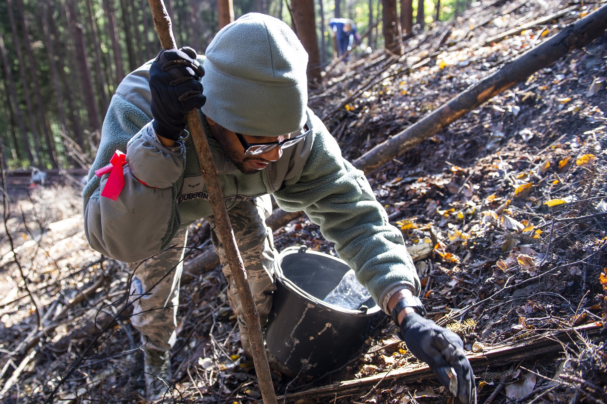 Airmen have worked in the dense wooded area digging through thick vegetation to recover F-16 parts.