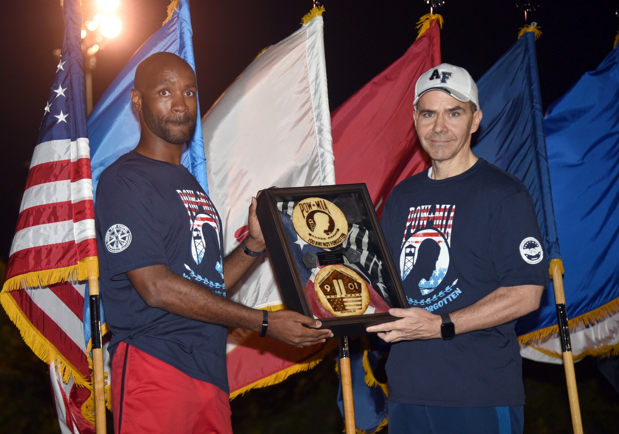 An image of the project officer presenting a shadow box to the vice commander