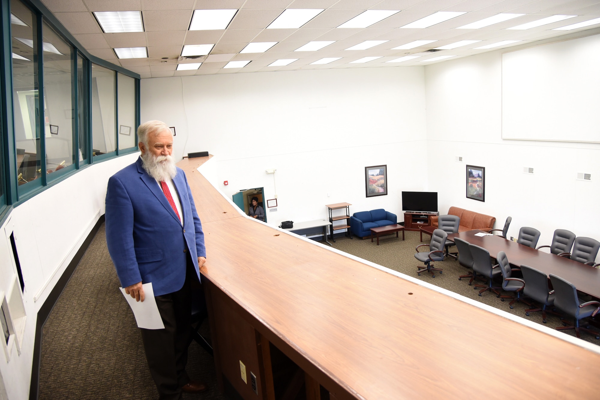 An image of the 38th Engineering Squadron Director standing in front of the table where the 746th Aircraft Control and Warning Squadron would coordinate tactical communication.