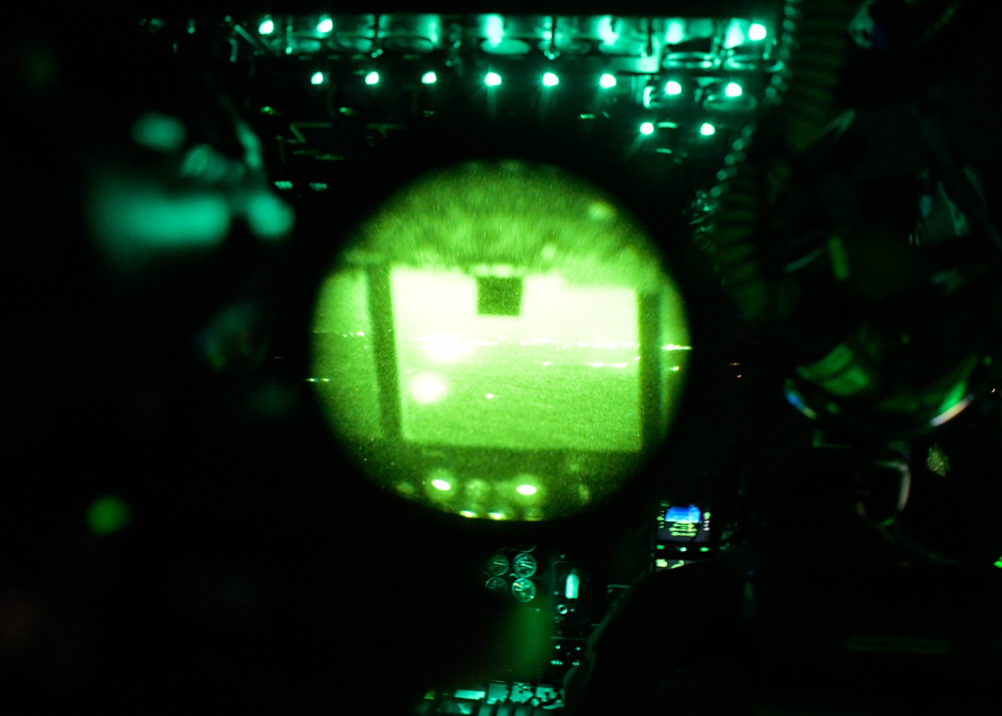 The view from a pair of night vision goggles while in the cockpit of a C-130H3 Hercules from Dobbins Air Reserve Base, Georgia, during a Night Tactical Air-Land Mission during Exercise Real Thaw 2019 at Beja Air Base, Portugal, Oct. 2, 2019. Real Thaw is a Portuguese-led large joint and combined force exercise held annually where Dobbins provided aerial support. (U.S. Air Force photo/Senior Airman Josh Kincaid)