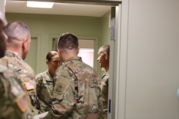 Sgt. Major of the Army Micheal A. Grinston, speaks with Spc. Kinsley Adams, 1st Theater Sustainment Command, during his visit to Fort Knox, Ky.