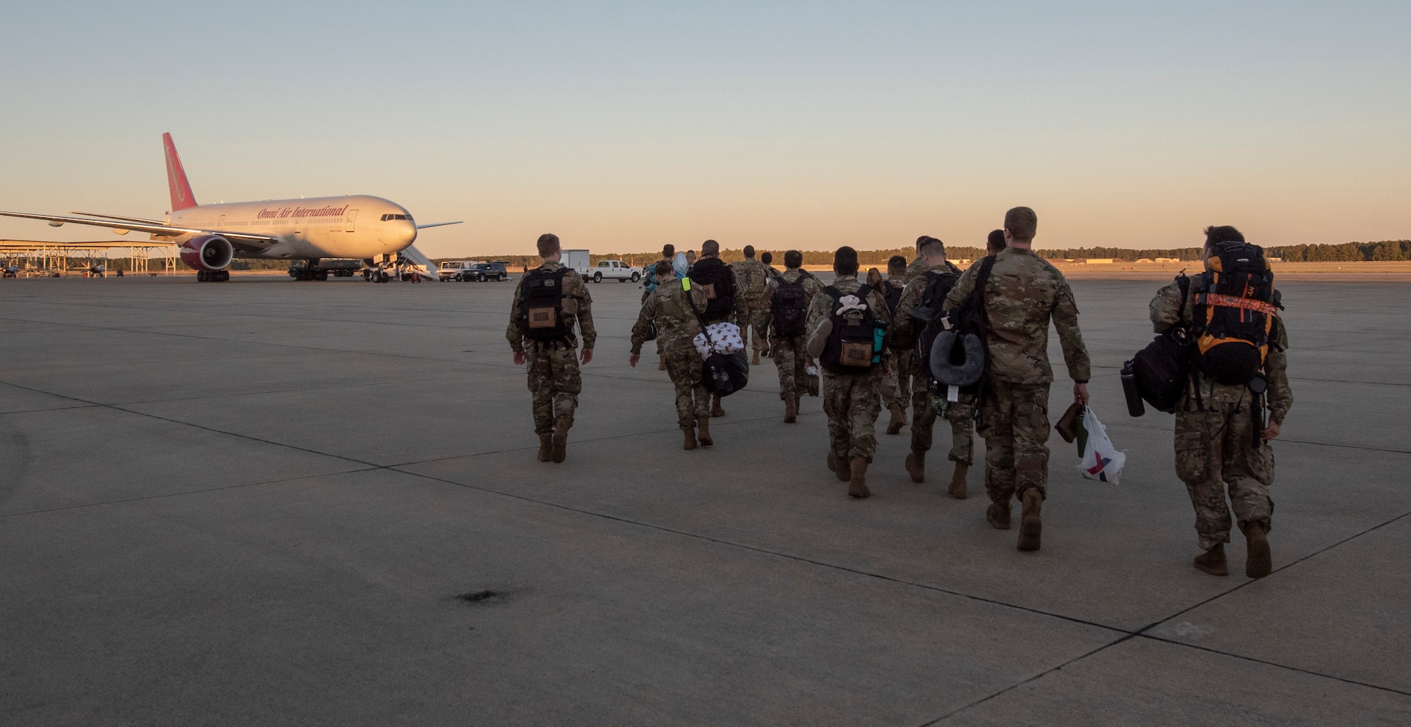 Members of the 79th Aircraft Maintenance Unit (AMU) walk towards a commercial aircraft on the flight line at Shaw Air Force Base (AFB), South Carolina, Oct. 17, 2019.