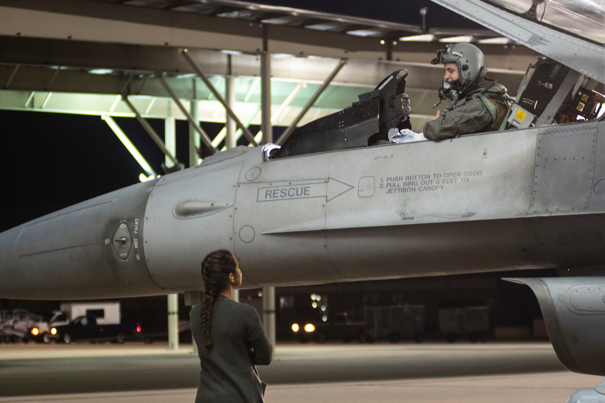 An F-16CM Viper pilot assigned to the 79th Fighter Squadron (FS) communicates with his spouse prior to departure at Shaw Air Force Base, South Carolina, Oct. 21, 2019.