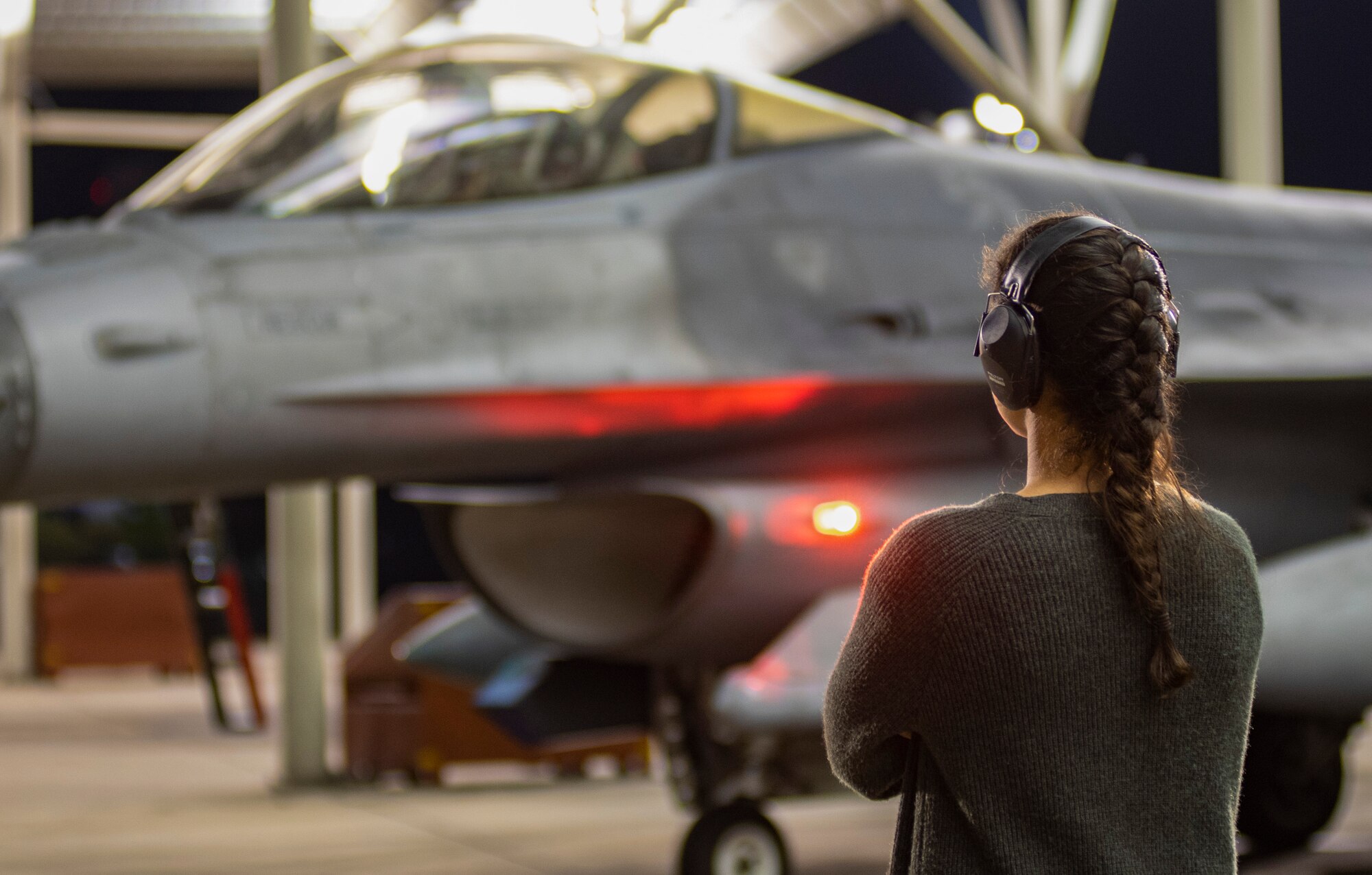 A pilot’s spouse watches an F-16CM Viper pilot assigned to the 79th Fighter Squadron prepare for takeoff at Shaw Air Force Base, South Carolina, Oct. 21, 2019.