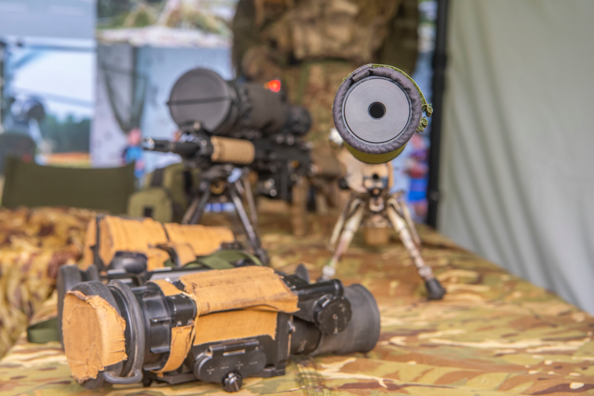 A collection of Royal Air Force Regiment weapons and scopes sits on a table at RAF Waddington, England, Oct. 22, 2019. Airmen received a briefing on airfield force protection during the RAF Air Combat Power visit. (U.S. Air Force photo by Airman 1st Class Joseph Barron)