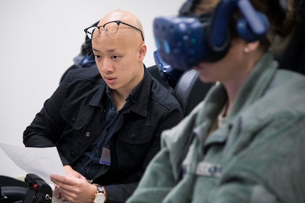 Derrick Ng, NASA aerospace engineer intern, monitors the virtual reality flight sortie of 1st Lt. April Albanese, Pilot Training Next student, as part of collaborative research agreement between Air Education and Training Command and NASA Oct. 22 at Joint Base San Antonio-Randolph. The goal of the agreement is to help both AETC and NASA collect physiological and cognitive data and leverage each organization's knowledge and skills to maximize learning potential for individual students.